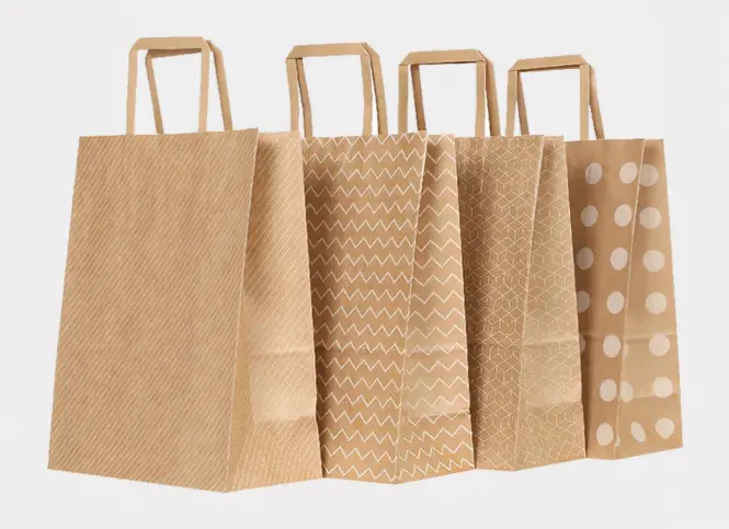 Set of brown kraft paper shopping bags with twist paper handles in natural, textured, and polka dot prints